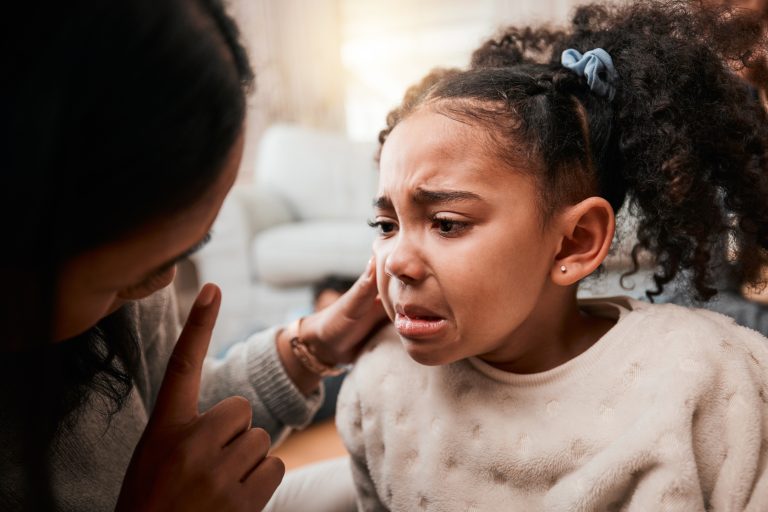 Discipline, angry and mother with girl, home and unhappy with expression, crying and naughty. Serious, female child and mama with conflict, sad and conversation with reprimand, punish kid and advice